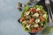 Organic salad with chicken, cherry tomatoes, quail eggs, black olives and microgreens against on light blue background, Healthy