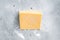 Organic Sharp Cheddar Cheese in vacuum packaging. Gray background. Top view