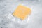 Organic Sharp Cheddar Cheese in vacuum packaging. Gray background. Top view