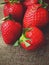 Organic strawberries on rustic linen background