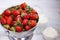 Organic strawberry and whipped cream in glass bowls