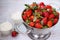 Organic strawberry and whipped cream in glass bowls