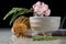 Organic tea matcha latte with bamboo chasen and bamboo spoon in a bowl on gray marble with beautiful oleander flowers. Japanese