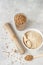 Organic uncooked buckwheat grains in glasses, buckwheat flour in a bowl and dried buckwheat soba noodles.