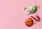 Organic vegetables artichoke ripe juicy tomato hot chili peppers garlic cloves floating levitating on pink background