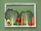 Organic vegetables picture with wooden border on green