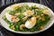 Organic vitamin salad of green peas, micro greens, nuts and eggs close-up on a plate. horizontal