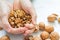 Organic walnuts in the heart on wooden background