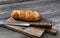 Organic whole wheat loaf with curated knife on cutting board in close up layout