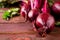 Organic young beets with green leaves on wooden table