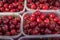 Organics cherries in plastic boxes sold at local city market