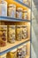 Organization in the kitchen. Italian pasta in glass jars on the shelf