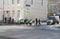 Organized group of children in reflective vests crossing the road accompanied by adults in Moscow