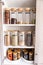 Organized labeled food pantry in a home kitchen with spices