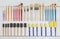 Organized new paintbrushes and applicators on white wooden board