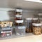 An organized pantry shelf with various types of cookies cereal and snacks and snacks