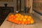 Organized pile of freshly picked, local, ripe, oranges