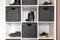 Organized shoe rack in modern interior, various footwear on wooden shelf, storage for shoes in a modern home