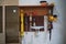 An organized tool rack holds essential woodworking tools, a level, saws, and clamps, reflecting a well-maintained and