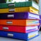 Organized workspace Stack of colorful file folders on office table