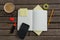 Organizer, coffee, mobile phone and stationery on wooden plank