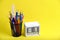 Organizer with pencils and ruler, stationery stand and wooden calendar with date September 01 yellow background.