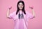 ?orgeous body positive Latin woman in a pink hoodie with dumbbells