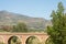 ORGIVA, SPAIN - 16 MAY 2022 The Seven Eyes Bridge over the Guadalfeo river near the tiny mountain village of Orgiva, Spain