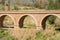 ORGIVA, SPAIN - 16 MAY 2022 The Seven Eyes Bridge over the Guadalfeo river near the tiny mountain village of Orgiva, Spain