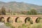 ORGIVA, SPAIN - 16 MAY 2022 The Seven Eyes Bridge over the Guadalfeo river near the tiny mountain village of Orgiva, Spain