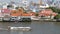 Oriental boat floating on river in Krungthep city. Modern transport vessel floating on calm Chao Praya river on sunny day in