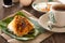 Oriental breakfast set in Malaysia consisting of coffee, nasi lemak, toast bread and half-boiled egg