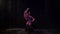 oriental dance under rain at night, enigmatic shot of young alluring woman sitting on floor and moving hands