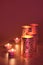 Oriental metal lanterns and tea lights. Dark red, magenta, brown and golden monochromatic background.