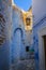 Oriental narrow street with blue houses in Medina, Hammamet Tunisia