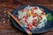 Oriental rice noodles Udon with sweet pepper, mushrooms. On a wooden background