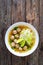 Oriental soup with meatballs, rice noodles and sprouts on wooden table