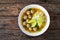 Oriental soup with meatballs, rice noodles and sprouts on wooden table