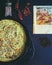 Oriental still life with homemade pie, spices and page of vintage book from Asia.