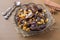 Oriental sweets, dried fruit dates and raisins, cinnamon and star anise in a plate on a wooden background.