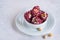 Oriental sweets, Turkish delight with rose petals and pistachios in a white bowl on a light concrete background