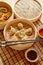 Oriental traditional chinese dumplings served in the wooden steamer