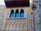 Oriental window made in moorish tradition downtown Toledo, Spain. Beige brick wall with arabic ornate, so called Mudejar style