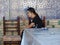 Oriental women in front of a decorated ancient ceramic wall to Khiva in Uzbekistan.