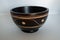 Oriental wood bowl with notches on white background