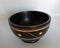 Oriental wood bowl with notches on white background