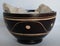 Oriental wood bowl with notches white stones inside on white background