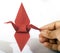 Origami Crane in hand  on white background