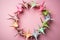 Origami cranes in different shades of pink, arranged in a circular pattern on a pastel-colored background