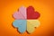 Origami hearts made with colored paper for congratulations on Valentine`s Day for couples in love, on orange background